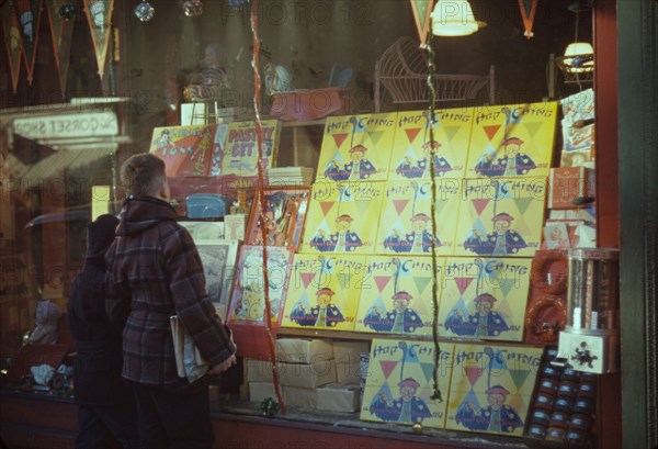 Boy looking at store window display of toys, between 1941 and 1942. Creator: Unknown.