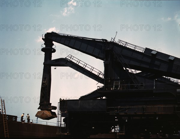 Pennsylvania R.R. ore docks, unloading iron ore from a lake freighter..., Cleveland, Ohio, 1943. Creator: Jack Delano.