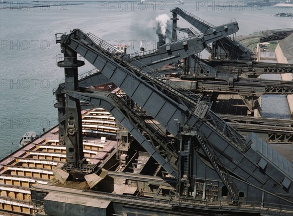 Pennsylvania R.R. ore docks, unloading iron ore from a lake freighter..., Cleveland, Ohio, 1943. Creator: Jack Delano.