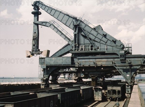 Unloading a lake freighter at the Pennsylvania Railroad iron ore docks...Cleveland, Ohio, 1943. Creator: Jack Delano.