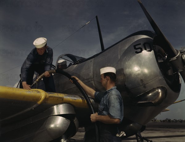 Feeding an SNC advanced training plane its essential supply of gas...Corpus Christi, Texas, 1942. Creator: Howard Hollem.