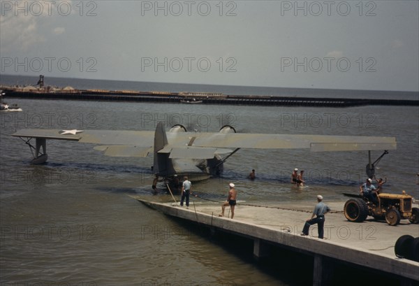 Working with a sea-plane at the Naval Air Base, Corpus Christi, Texas, 1942. Creator: Howard Hollem.