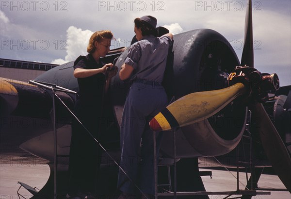 Bowen, a riveter, and Olsen, her supervisor, in the Assembly...Air Base, Corpus Christi, Texas, 1942 Creator: Howard Hollem.