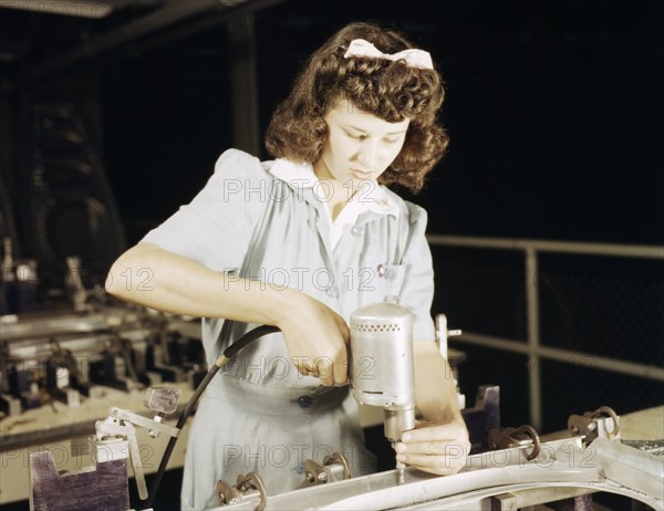 Drilling a wing bulkhead for a transport plane at the Consolidated Air..., Fort Worth, Texas, 1942. Creator: Howard Hollem.