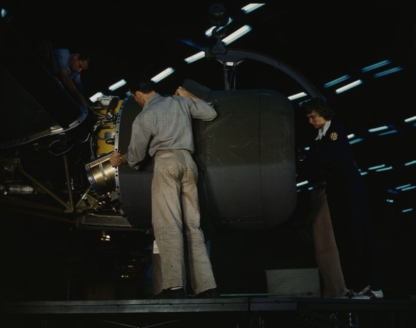 Lowering an engine in place in assembling a C-87...Consolidated Aircraft..., Fort Worth, Texas, 1942 Creator: Howard Hollem.