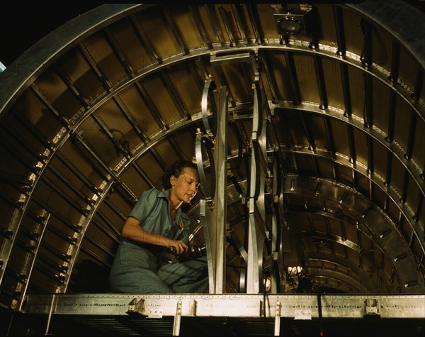 Installing oxygen flask racks above the flight...Consolidated Aircraft..., Fort Worth, Texas, 1942. Creator: Howard Hollem.