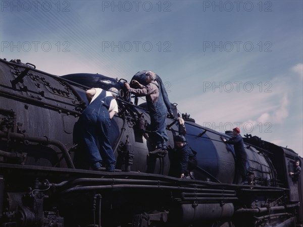 C. & N.W. R.R., women wipers employed at the roundhouse cleaning one of the..., Clinton, Iowa, 1943. Creator: Jack Delano.