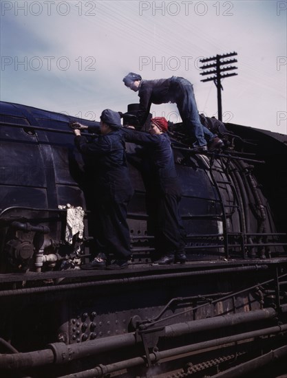 C. & N.W. R.R., women wipers at the roundhouse cleaning one of the giant..., Clinton, Iowa, 1943. Creator: Jack Delano.