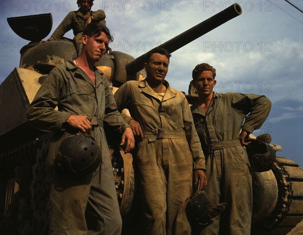 Tank crew standing in front of an M-4 tank, Ft. Knox, Ky., 1942. Creator: Alfred T Palmer.