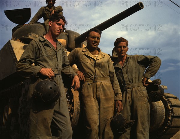 Tank crew standing in front of an M-4 tank, Ft. Knox, Ky., 1942. Creator: Alfred T Palmer.