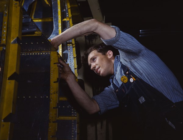 A wing brace assembly for a B-25 bomber is prepared...North American Aviation, Inc., Calif., 1942. Creator: Alfred T Palmer.