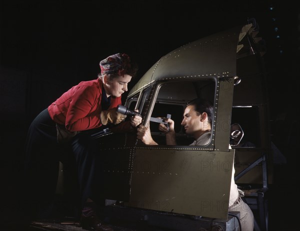 Riveting team working on the cockpit shell of a...Douglas Aircraft Co., Long Beach, Calif. , 1942. Creator: Alfred T Palmer.