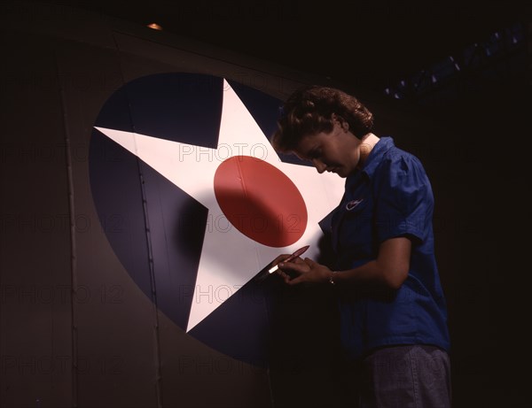 A candid view of one of the women workers touching up...Vultee's Nashville division, Tennessee, 1943 Creator: Alfred T Palmer.