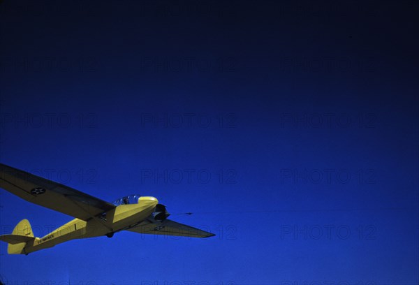 A Marine Corps glider being towed by a power plane from Page Field, at Parris Island, S.C., 1942. Creator: Alfred T Palmer.