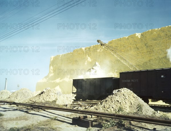 Loading box cars with sulphur, Freeport Sulphur Co., Hoskins Mound, Texas, 1943. Creator: John Vachon.