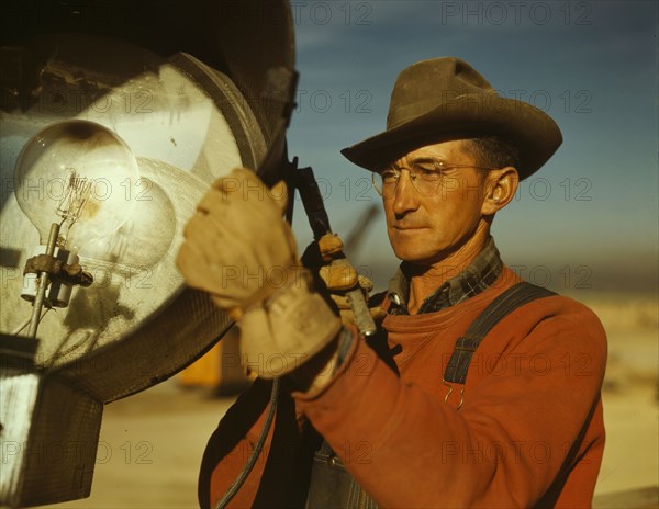 Servicing one of the floodlights that turn night into day..., Columbia Steel Co., Geneva, Utah, 1942 Creator: Andreas Feininger.