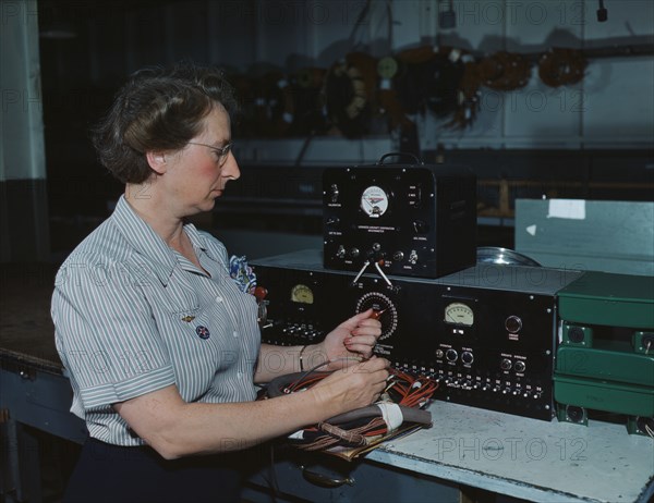 Working with the electric wiring at Douglas Aircraft Company, Long Beach, Calif., 1942. Creator: Alfred T Palmer.