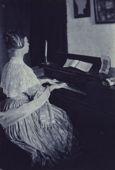 At the spinet, c1900. Creator: Frances S. Allen.