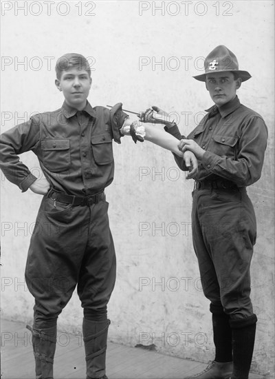 Boy Scouts Training Demonstration, 1912. [Tourniquet].