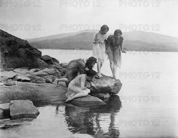 Four figures at water edge, c1914. Creator: Frances Benjamin Johnston.