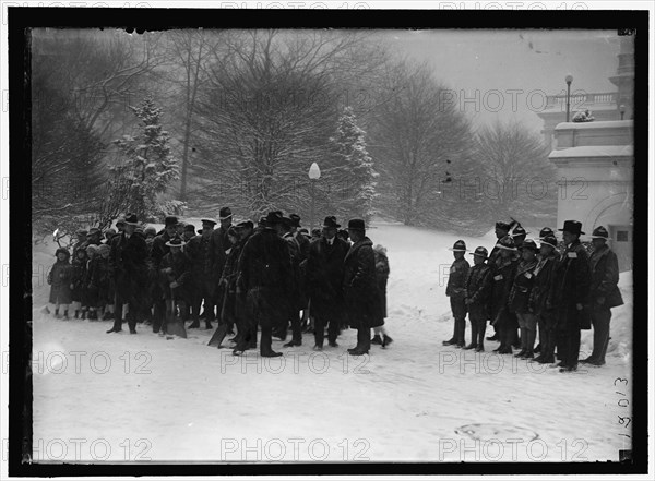 Group outside White House in snow, between 1913 and 1918.