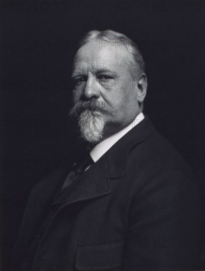 Man with mustache and goatee, facing left, half-length portrait, c1900.