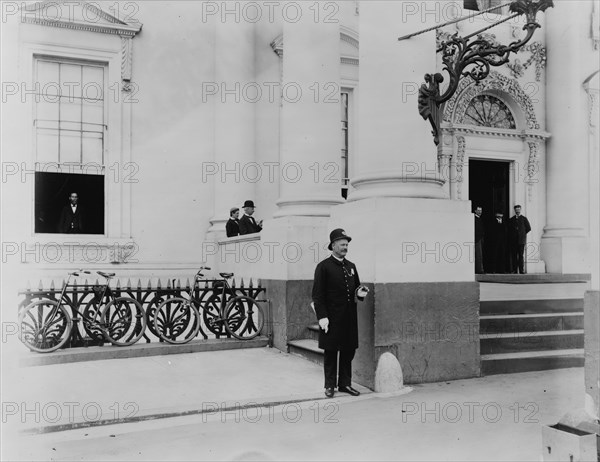 Policeman standing guard at entrance to White House, between 1889 and 1906.