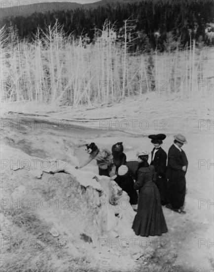 A group of tourists explore land formations in Yellowstone National Park, 1903.