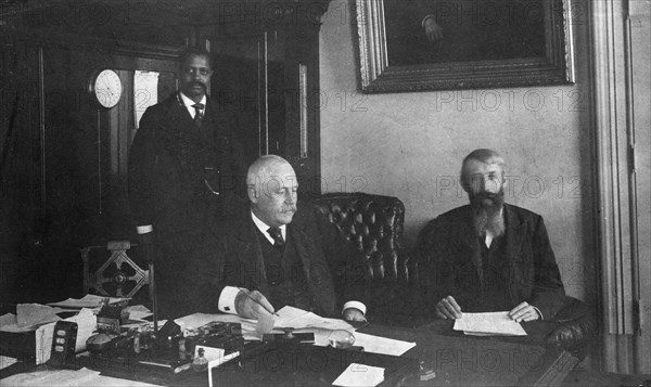 Three men in office in Bureau of Engraving and Printing, Washington, D.C., 1889 or 1890.