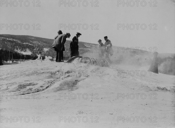 A group of tourists explore a geyser in the Upper Geyser Basin in Yellowstone National Park, 1903.