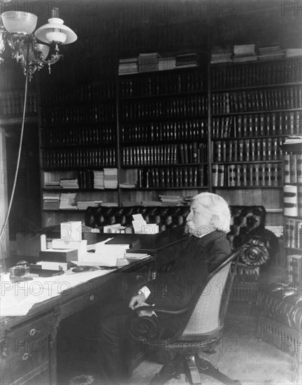 Melville Weston Fuller, full-length portrait, seated at desk, facing left, c1899. Creator: Frances Benjamin Johnston.