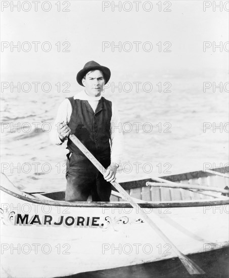 Indian guide for the rapids, standing in canoe, in the Sault Sainte Marie region of Michigan, 1903. Creator: Frances Benjamin Johnston.