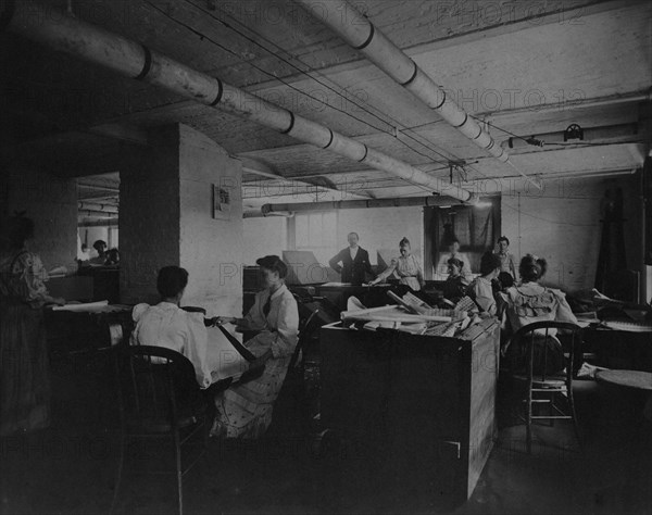 Workers taking mucilaged sheets of postage stamps from the drying box in the gumming..., c1895. Creator: Frances Benjamin Johnston.