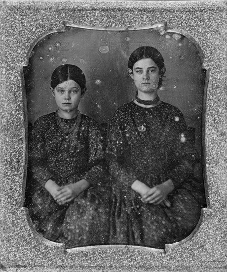 Group portrait of two unidentified girls, three-quarter length, seated, facing front, c1840 - 1860. Creator: Unknown.