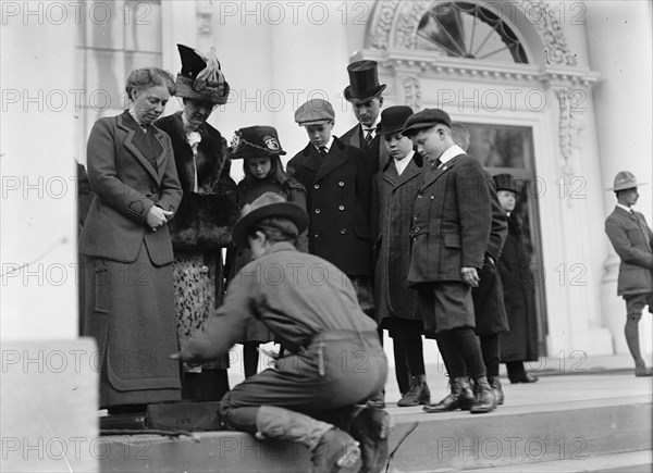 Boy Scouts - Visit of Sir Robert Baden-Powell To D.C. Making Fire; Mrs. Taft Watching, 1911. Creator: Harris & Ewing.