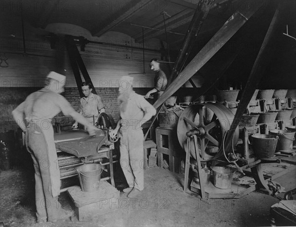 Workers grinding and processing the ink used to print paper money at the Bureau of Engrav..., c1890. Creator: Frances Benjamin Johnston.