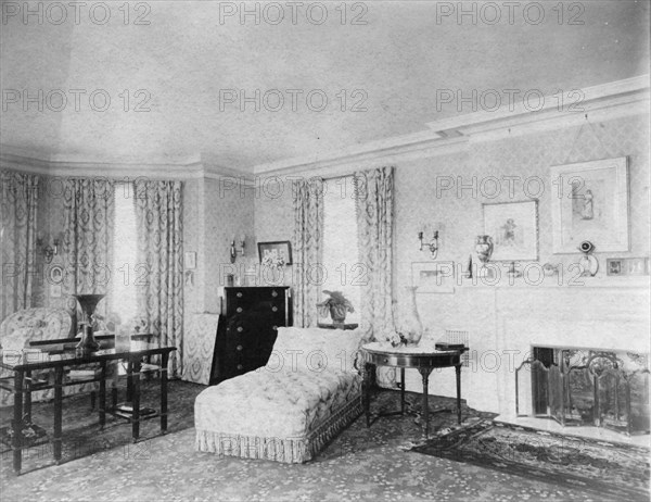 Bedroom with fireplace, and padded chaise longue, in home of...Greenwich, Connecticut, 1908. Creator: Frances Benjamin Johnston.