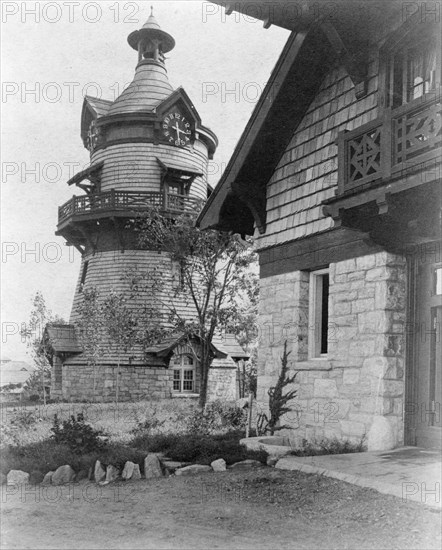 Windmill-shaped clock tower at left, and part of garage of Edmund..., Greenwich, Connecticut, 1908. Creator: Frances Benjamin Johnston.