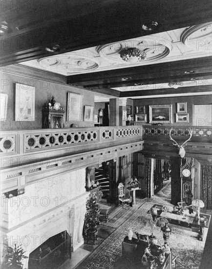 Room with balcony, paintings, fireplace, grandfather clock, and elk..., Greenwich, Connecticut, 1908 Creator: Frances Benjamin Johnston.