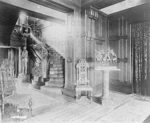 Hall and stairway, with suit of armor at left, and statue of cow..., Greenwich, Connecticut, 1908. Creator: Frances Benjamin Johnston.