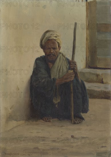 Luxor, Arab holding a stick sitting in a street, 1892.