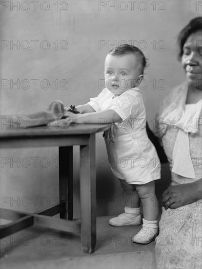 Vincent P. Aherns, Portrait, 1933. White child with African American nanny.