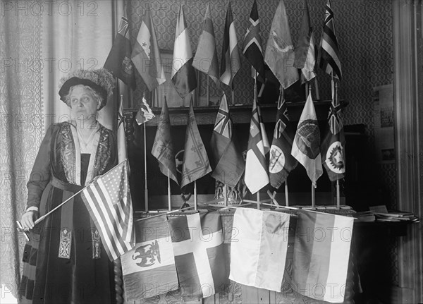 Mrs. Carrie Chapman Catt with Flags of 22 Nations, 1917. Creator: Harris & Ewing.