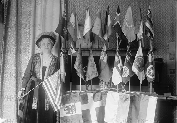 Mrs. Carrie Chapman Catt with Flags of 22 Nations, 1917. Creator: Harris & Ewing.