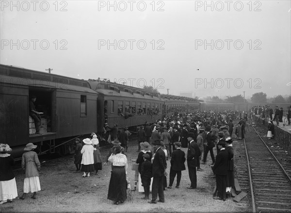 Army, U.S. Troops In Training, 1917. Crowds waving off a train packed with soldiers.