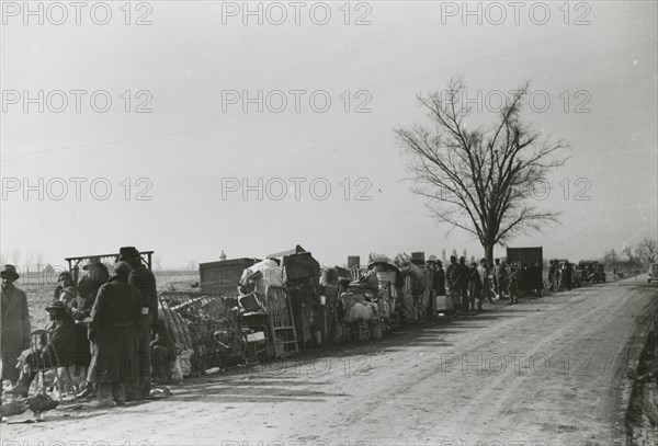 Evicted African American sharecroppers standing with their belongings along Highway 60..., Jan 1939. Creators: Farm Security Administration, Arthur Rothstein.