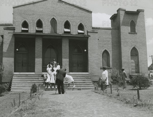 Ushers of an African American church standing on church steps and getting ready to pose..., May 1940 Creators: Farm Security Administration, Jack Delano.