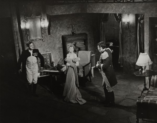 Two men and woman in evening dress, 1938.