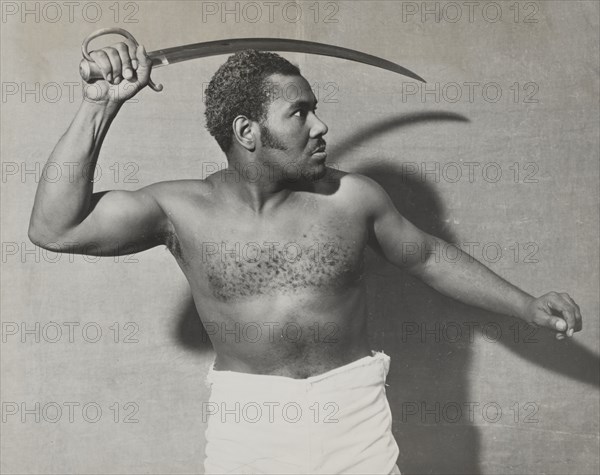 Rex Ingram, shirtless, with cutlass, 1938.