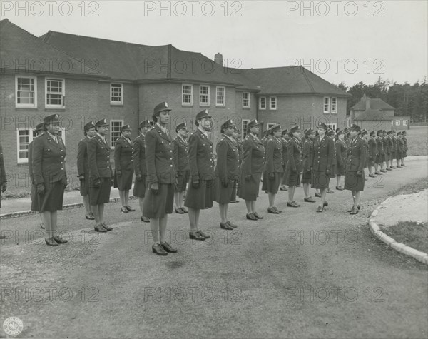 Army nurses standing at attention in front of their barracks and being inspected by..., 1939 - 1945. Creator: Unknown.